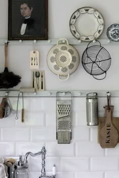 a kitchen wall with plates and utensils on it