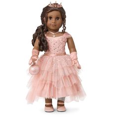 the doll is wearing a pink dress and tiara