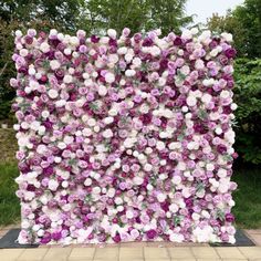 a large purple and white flower covered wall