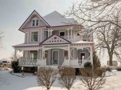 a large white house sitting in the snow