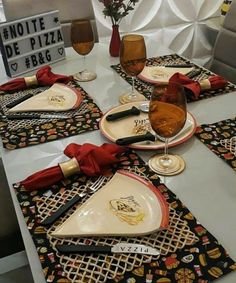 the table is set with wine glasses and plates