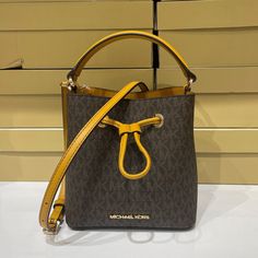 New With Tag Michael Kors Suri Mini Bucket Satchel Shoulder Crossbody Bag Mk Signature Pvc Leather Brown Yellow(Marigold) 100% Authentic Retail: $328.00 Plus Tax **Please See The Measurement For The Size** This Bag Is Really Mini Eventhough Tag Said Small *The Model Is 5'11" And Size 2* *The Pictures Look Larger Than The Size* !!!No Dust Bag!!! Gold Toned Hardware Michael Kors Logo At Front Open Top With Drawstring No Lining 7"(L) X 7"(H) X 4"(D) Strap:18"-21" Very Clean, Smoke-Free And Pet-Free Yellow Shoulder Bag With Branded Hardware For Travel, Yellow Pouch Bucket Bag With Detachable Strap, Yellow Travel Bag With Branded Hardware, Yellow Bucket Bag With Detachable Strap, Michael Kors Yellow Shoulder Bag For Travel, Yellow Michael Kors Travel Bag, Michael Kors Yellow Travel Shoulder Bag, Designer Yellow Bucket Bag, Yellow Michael Kors Leather Shoulder Bag