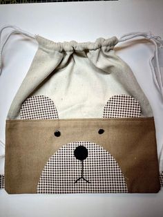 a drawstring bag with a bear face on it