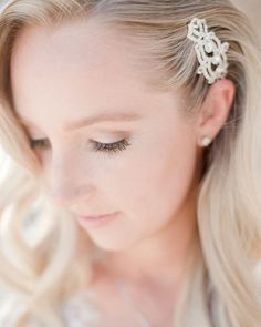 a woman with blonde hair wearing a white dress and a tiara on her head