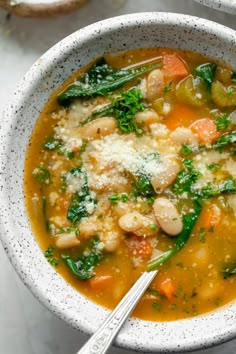 a white bowl filled with soup and vegetables