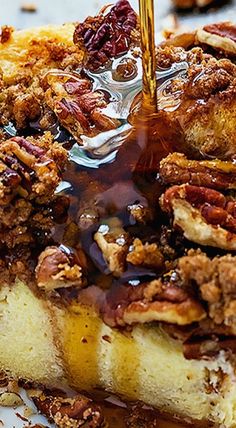 a close up of a plate of food with pecans and syrup on it's side