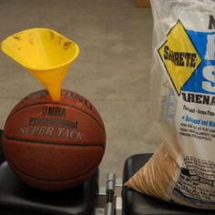 a basketball sitting on top of a black chair next to a bag of cheese grits