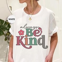 Promote kindness with our Bella Canvas t-shirt featuring the heartwarming "Always Be Kind" design.  This soft, stylish tee showcases colorful, distressed typography with a floral accent, making it perfect for anyone who believes in spreading kindness and positivity. Whether you're seeking a thoughtful gift or a new favorite tee, this shirt combines comfort and an inspiring message. 🛍️HOW TO ORDER: 1️⃣To begin, select the desired product type and size from the drop-down menu. 2️⃣Next, choose the Inspirational White T-shirt With Letter Print, Inspirational Letter Print White T-shirt, Inspirational White Pre-shrunk T-shirt, Inspirational White Graphic Print T-shirt, Distressed Typography, Spreading Kindness, Inspiring Message, Spread Kindness, Inspirational Message