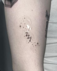 a person with a tattoo on their arm has a light bulb in the shape of a star