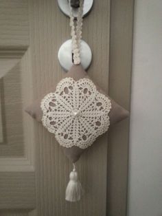 the door is decorated with white doily and tassels