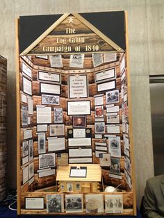 a display case with pictures and information about the log cabin camper of 1940 on it