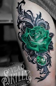 a green rose tattoo on the thigh