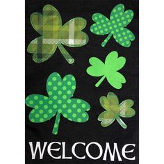 a welcome sign with four leaf clovers and polka dots on the front of it