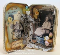 an open tin can with pictures and buttons in it