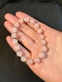 "This bracelet is AAA+ high quality natural rose quartz. It has subtle pink color and semi-translucent clarity, simply stunning!Additionally Each bead is separated with a small 2mm 14k gold accent spacer bead. Rose Quartz: Peace, Calming, Reassurance * AAA+ Rose Quartz 8mm * 14k Gold filled accent beads 2mm * Durable internal Japanese stretch cord * Gemstones are 100% genuine  ♡ View the store here: usagimarshmellow.etsy.com ♡Follow on instagram: https://www.instagram.com/usagimarshmellow L E N G T H Our bracelets measure 6.5\" and will fit most wrists. They can be customized upon request. Please message me if you have any concerns or want some extra help ♡ G I F T I N G  &  P A C K A G I N G Your bracelet will be packaged in a jewelry gift box or cotton to protect it during travel. . Mult Spiritual Rose Quartz Crystal Bracelet, Rose Quartz Crystal Bracelet With Natural Stones, Round Rose Quartz Crystal Bracelet With Natural Stones, Rose Quartz Natural Stones Round Bracelets, Round Rose Quartz Natural Stone Bracelets, Hand-strung Rose Quartz Crystal Bracelet Gift, Hand-strung Rose Quartz Crystal Bracelet For Healing, Rose Quartz Natural Stones Bracelet, Rose Gold Rose Quartz Crystal Bracelet With Round Beads