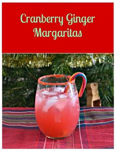 cranberry ginger margarita in a glass on a table next to a christmas tree