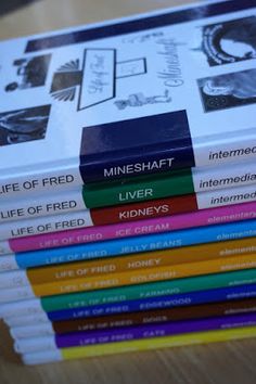 a stack of books sitting on top of a wooden table