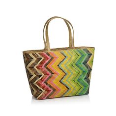 a multicolored woven bag with handles and handles on the front, sitting on a white surface