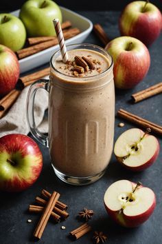 an apple smoothie with cinnamon sticks and apples in the background