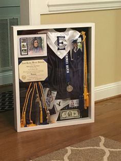 a display case with an award and other items in it on a wooden floor next to a wall