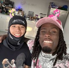 two people wearing bandanas and hats in a kitchen