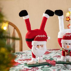 two christmas decorations are sitting on a table