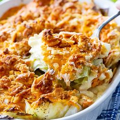 a casserole dish with potatoes and other toppings in a white baking dish