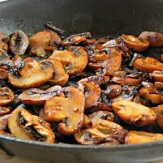 mushrooms are being cooked in a pan on the stove