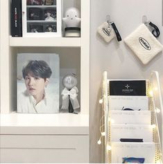 a white shelf with pictures and lights on it