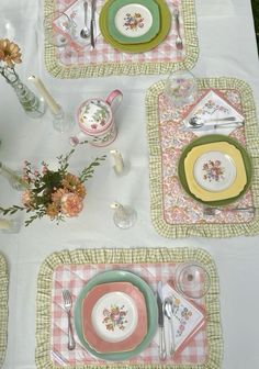 the table is set with dishes and place settings