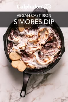 a cast iron skillet filled with s'mores dip and graham crackers