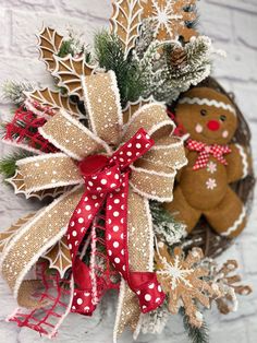 a christmas wreath with a gingerbread man and snowflakes hanging on the wall