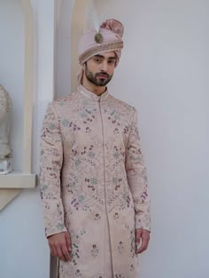 Editor's Note Featuring Our Work Of Art In Our Blush Pink Heavy Hand-embroidered Sherwani Set, With A Kaleidoscopic Floral Pattern Scattered All Over The Ensemble. Completing The Look With A Double-bordered Handmade Safa, And A Matching Blush Pink Hand-embroidered Stole. Paired With The New Jmc Accessories- Double Strap Tan Peshawari, And The Metal Kalgi. Fabric: Linen Silk Color: Blush Pink Component: Sherwani, Kurta, Churidar, Stole, Safa Care: Dry Clean Only About the Designer After establish Wedding Coat Suit, Indian Engagement Dress, Coat Suit For Men, Jatin Malik, Indian Groom Dress, Indian Engagement, Designer Blazers For Men