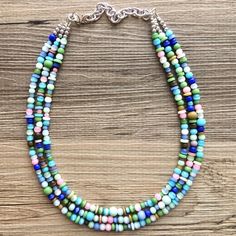 16 Inch Necklace with a 4 inch silver extender chain and silver lobster clasp. Shades of Jewel tones beads adorn this chunky 3 strand glass beaded necklace. Thank you for supporting American small business! 100% handmade. *Smoke and pet free home!* Hate to wait? Me too! I ship 6 days a week. Thank you for browsing my store! Check out my other items here: https://www.etsy.com/shop/PolkaDotDrawer?ref=si_shop Dark Blue Jewelry, Blue Jewelry Set, Blue Statement Necklace, 16 Inch Necklace, Chunky Statement Necklace, Bubble Necklaces, Brown Necklace, Chunky Jewelry, Jewelry Blue