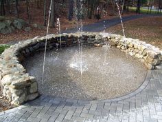 an outdoor fountain with water spouting from it