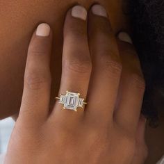 a woman's hand with a diamond ring on it