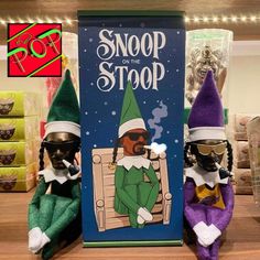 two elfs sitting next to each other in front of a sign that says snoop on the stop