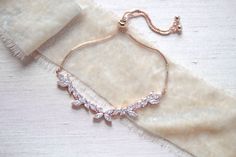 "This delicate vine inspired rose gold bracelet is the perfect, feminine finishing touch for a bride or bridesmaid! - Bracelet measures 10\" with adjustable slide clasp - Handcrafted with high quality cubic zirconia - Available in rose gold, yellow gold and rhodium (silver) finishes Browse My Entire Shop For More Jewelry & Accessories: https://www.etsy.com/shop/TheExquisiteBride Browse My Shop For Earrings: https://www.etsy.com/shop/TheExquisiteBride?section_id=14483895 Browse My Shop For Br Elegant Rose Gold Bracelets For Wedding, Dainty Cubic Zirconia Chain Bracelet For Wedding, Dainty Cubic Zirconia Wedding Chain Bracelet, Dainty Rose Gold Bracelets For Wedding, Adjustable Delicate Rose Gold Diamond Bracelet, Delicate Rose Gold Bracelets For Party, Elegant Wedding Diamond Bracelet With Adjustable Chain, Elegant Rose Gold Chain Bracelet For Wedding, Elegant Rose Gold Chain Bracelet For Party