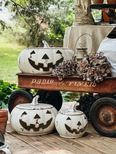 pumpkins are sitting on top of an old wagon