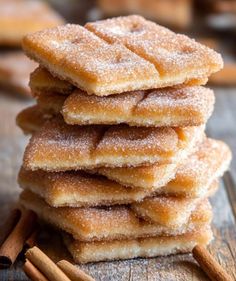 cinnamon sugar cookies stacked on top of each other with cinnamon sticks next to them in the foreground