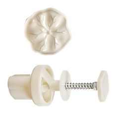 a pair of white plastic buttons and screws