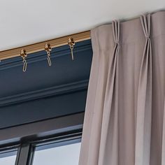 the curtain rod is hanging on the side of the window