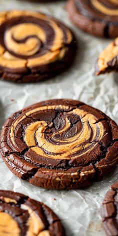 chocolate cookies with orange swirls on white paper