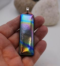 From our SW London based studio - Lallubinx produce the most beautiful fused glass jewellery and other items.  We make sure that all pieces are original items of art, made with love and care.  Here at Lallubinx Studios we love glass with a passion.  Our stunning, hand made rainbow dichroic pendant is a one off design.  It has a solid silver bale, gold plated (a chain is not incuded).  It is made of two layers of 2mm glass and has a matt finish.  The pendant is 6cm long by 2cm wide. would make a wonderful gift for someone special in your life. FREE UK Postage. Comes beautifully boxed and presented and packaged/posted with loving care. Modern Rainbow Jewelry Gift, Modern Rainbow Jewelry For Gifts, Modern Rainbow Colored Jewelry For Gifts, Modern Rainbow Jewelry For Gift, Rectangular Rainbow Jewelry For Gifts, Rainbow Glass Jewelry Gift, Rainbow Glass Jewelry For Gifts, Dichroic Pendant, Fused Glass Pendant