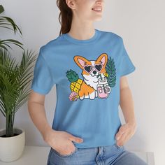 Introducing our Summer Corgi Unisex Graphic Tee – a must-have addition to your warm-weather wardrobe that combines adorable corgi charm with the laid-back vibes of summer! This tee isn't just clothing; it's a fun and stylish way to celebrate your love for these delightful pups and the sunny season. Crafted for both men and women who adore corgis, this tee is perfect for adding a touch of whimsy to your summer look, whether you're lounging at the beach or soaking up the sun by the pool. Featuring a playful corgi graphic and made from high-quality materials for comfort and durability, this tee is sure to become a favorite in your collection. Whether you're a proud corgi lover or searching for the perfect gift for a fellow dog enthusiast, our Summer Corgi Unisex Graphic Tee is guaranteed to b Dog Print Crew Neck Graphic Tee, Summer Dog Print Relaxed Fit T-shirt, Summer Relaxed Fit T-shirt With Dog Print, Trendy Crew Neck T-shirt With Dog Print, Relaxed Fit Short Sleeve Tops With Dog Print, Cotton Crew Neck Top With Dog Print, Summer Dog Print Graphic Tee, Summer Dog Print Short Sleeve Top, Summer Short Sleeve T-shirt With Dog Print