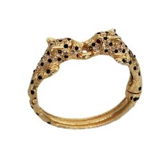 Vintage 80's DOUBLE LEOPARD Gold Tone and Black Spotted Statement Bracelet Condition:  Pre-owned, excellent!  No wear of note. Measurements:  Approximately 6.25 inch inner circumference, 0.5 inches at the widest point. Best fits a small to small/medium wrist Gorgeous and rare piece from the 1980's. The bracelet is a double leopard with a textured gold tone finish and black enameled spots accented with red crystal eyes. This particular leopard is very charming and perfect to layer up! Secure snap Cartier Leopard, Leopard Jewelry, Leopard Bracelet, Crystal Eyes, Jewelry Chest, Crystal Eye, Statement Bracelet, Red Crystals, Black Spot