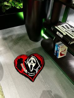 a heart shaped rug sitting on top of a wooden floor next to a book shelf