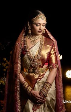 a woman in a white and gold sari