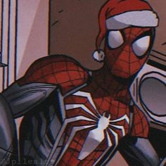 a spider man in a red and white suit with a santa hat on his head