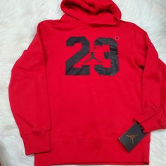 New With Tags Jordan Red Hoodie Size Medium = 10/12 Years Size Small = 8/10 Years Red Hooded Fleece Top, Red Sports Hoodie With Adjustable Hood, Sporty Red Hooded Top, University Red Hooded Top For Winter, Red Fleece Sports Top, Sporty Red Fleece Top, Red Fleece Sweatshirt With Adjustable Hood, Red Sporty Winter Sweatshirt, Red Sporty Sweatshirt With Adjustable Hood